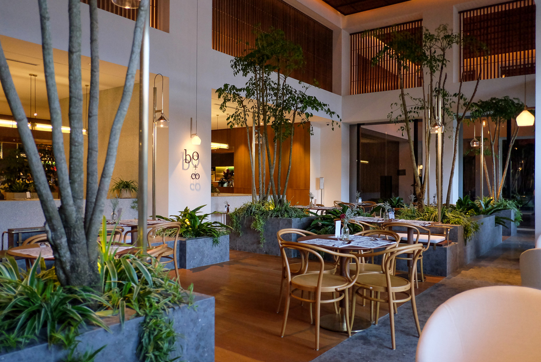 Warm contemporary Bangsar restaurant with greenery and dining tables